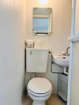 a small bathroom with a toilet and a sink at Toho so Inn in Tokyo