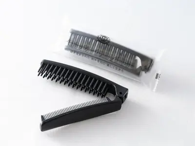 a hairbrush and a comb on a white surface at APA Hotel Shinjuku Kabukicho Tower in Tokyo