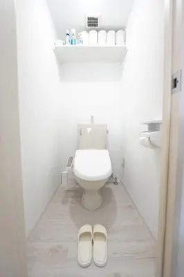 a bathroom with a toilet and a pair of slippers at 70 \u5e73\u65b9 - \u5927\u4e45\u4fdd - \u65b0\u5bbf 1 \u7ad9\u5730 - Ikeman St - \u6b4c\u821e\u4f0e\u753a - 2 \u6d74\u5ba4 2 \u536b\u751f\u95f4 in Tokyo
