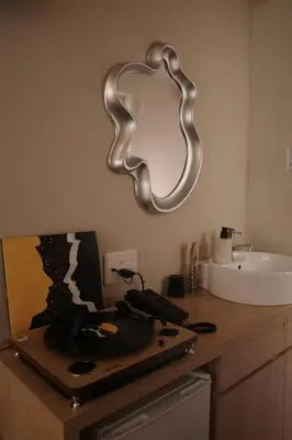 a bathroom with a sink and a mirror on the wall at etoe Hotel Shinjuku in Tokyo