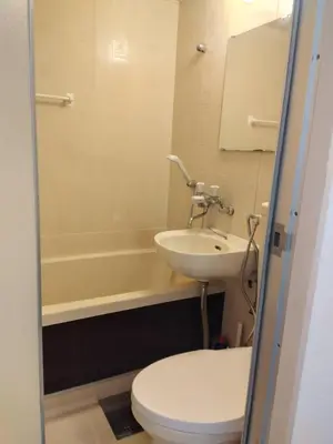 a bathroom with a toilet and a sink and a tub at SunandMoon\u30db\u30c6\u30eb401 in Tokyo