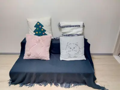 a bed with three pillows and a christmas tree at SunandMoon\u30db\u30c6\u30eb401 in Tokyo