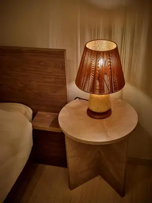 a table with a lamp on it next to a bed at LUXU Urban Shinjuku - 4min to Shinjuku, 10min to Shibuya in Tokyo
