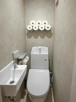 a bathroom with a toilet and a sink and two plates at LUXU Urban Shinjuku - 4min to Shinjuku, 10min to Shibuya in Tokyo