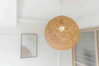 a orb light fixture hanging from a wall next to a door at Aurora 4 in Tokyo