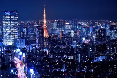 a lit up city at night with the eiffel tower at \u3055\u304f\u3089\u30b3\u30f3\u30d5\u30a9\u30fc\u30c8 in Tokyo