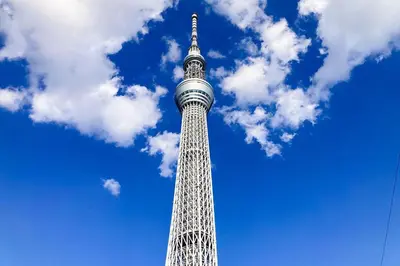 a tall tower with a blue sky and clouds at \u3055\u304f\u3089\u30b3\u30f3\u30d5\u30a9\u30fc\u30c8 in Tokyo