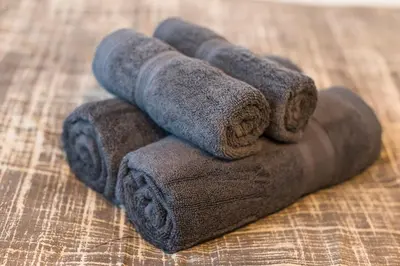 a pile of rolled up towels on a table at Villa Wisteria Kitazawa -apartment hotel- in Tokyo