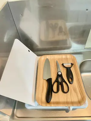 a cutting board with a pair of scissors on it at YMK Oshiage 3A in Tokyo