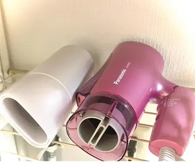 a purple and white hair dryer sitting on a shelf at Shiro HAKU in Tokyo