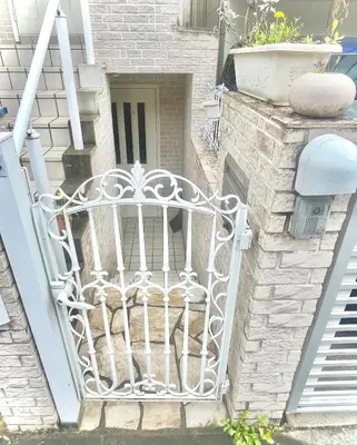 a white gate on the side of a building at Shiro HAKU in Tokyo