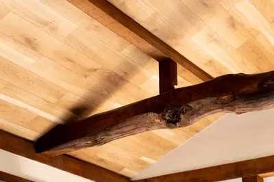 a wooden ceiling with a log on top of it at Renovated House Crossroads Katsushika in Tokyo