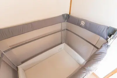 a corner of a bed in a room at Renovated House Crossroads Katsushika in Tokyo