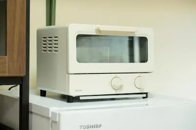 a white microwave sitting on top of a counter at Renovated House Crossroads Katsushika in Tokyo