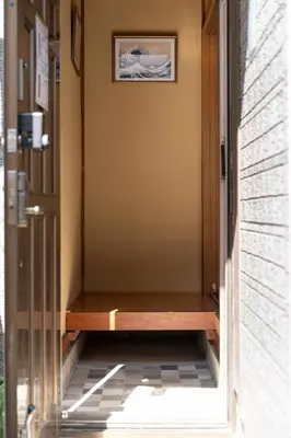 a door leading to a porch with a wooden bench at Renovated House Crossroads Katsushika in Tokyo