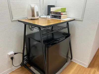 a table with a computer monitor and books on it at 西巣鴨 Cozy for 4-12guests 3BR House-3Showers &3Toilets in Tokyo