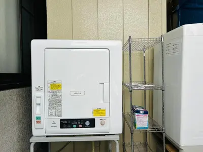a microwave oven sitting on a shelf next to a refrigerator at 西巣鴨 Cozy for 4-12guests 3BR House-3Showers &3Toilets in Tokyo