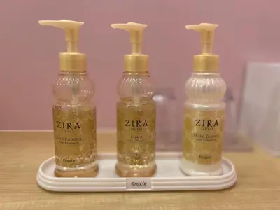 three glass bottles on a white tray with gold liquids at Stay&resort Luce ルーチェ in Urayasu