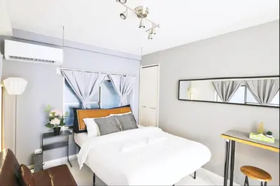 a bedroom with a white bed and a mirror at NEW! Shibuya Square Prime Unit, Heart of Tokyo! in Tokyo