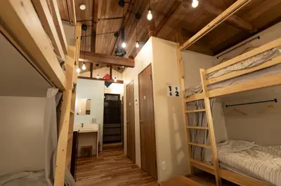 a room with two bunk beds and a desk at \u5343\u5bff\u5bbf \u7384 in Tokyo