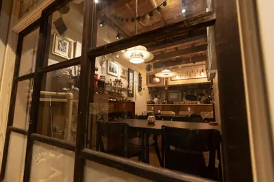 a dining room with a table and chairs through a window at \u5343\u5bff\u5bbf \u7384 in Tokyo