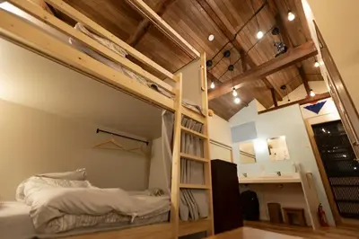 a bedroom with a bunk bed and a ladder at \u5343\u5bff\u5bbf \u7384 in Tokyo