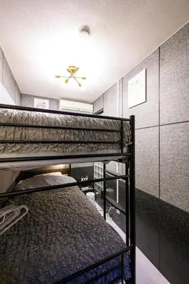 a bedroom with two bunk beds in a room at 4min Shinjuku by sub Cozy Mini Room in Tokyo