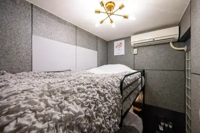 a bedroom with a bed and a ceiling fan at 4min Shinjuku by sub Cozy Mini Room in Tokyo