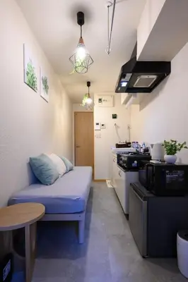 a small living room with a couch and a table at 4min Shinjuku by sub Cozy Mini Room in Tokyo