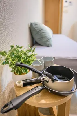 a table with a frying pan and plants on it at 4min Shinjuku by sub Cozy Mini Room in Tokyo