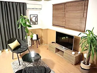 a living room with a flat screen tv and plants at Palette house Spacious 56 sqm Tokyo Apartment near Station in Tokyo