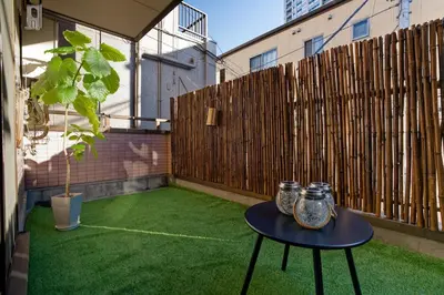 a small patio with a table and a fence at Palette house Spacious 56 sqm Tokyo Apartment near Station in Tokyo