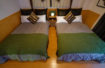 two beds sitting next to each other in a room at Palette house Spacious 56 sqm Tokyo Apartment near Station in Tokyo