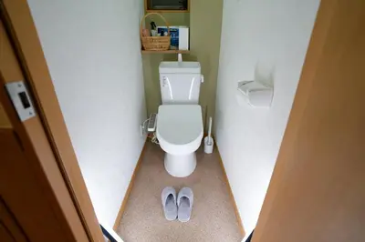 a bathroom with a toilet and a pair of shoes at Palette house Spacious 56 sqm Tokyo Apartment near Station in Tokyo