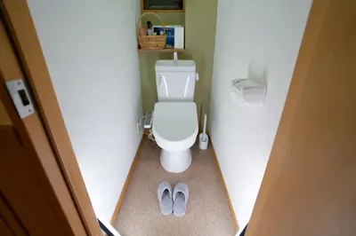 a small bathroom with a toilet and pair of shoes at Palette house Spacious 56 sqm Tokyo Apartment near Station in Tokyo