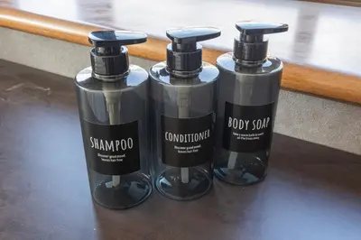 three bottles of soap sitting on a table at The Nest Koenji Cozy Stay near Station Easy Access to Shinjuku in Tokyo