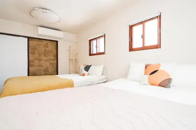 two beds in a room with white walls and windows at New Large Space 8ppl Flat Apt 2brs&tub in Tokyo