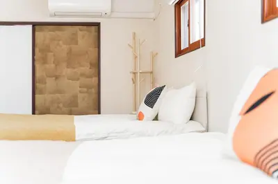 a bedroom with two beds and a window at New Large Space 8ppl Flat Apt 2brs&tub in Tokyo