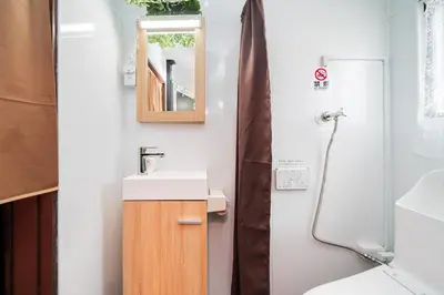 a bathroom with a sink and a mirror at New Large Space 8ppl Flat Apt 2brs&tub in Tokyo