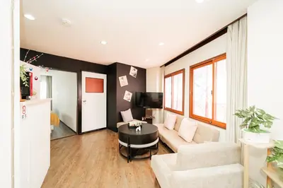 a living room with a couch and a table at New Large Space 8ppl Flat Apt 2brs&tub in Tokyo