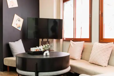 a living room with a couch and a table at New Large Space 8ppl Flat Apt 2brs&tub in Tokyo