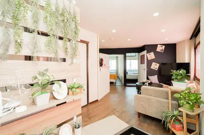 a living room with potted plants on the wall at New Large Space 8ppl Flat Apt 2brs&tub in Tokyo