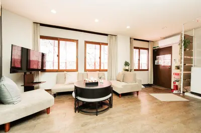 a living room with a table and a tv at New Large Space 8ppl Flat Apt 2brs&tub in Tokyo