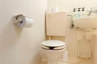 a bathroom with a white toilet and a sink at \u30a8\u30de\u30fc\u30ec\u65b0\u5bbf401\u53f7\u5ba4 in Tokyo