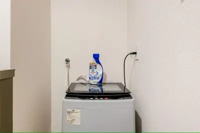 a bottle of cleaner sitting on top of a refrigerator at \u30a8\u30de\u30fc\u30ec\u65b0\u5bbf401\u53f7\u5ba4 in Tokyo
