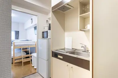 a small kitchen with a sink and a refrigerator at \u30a8\u30de\u30fc\u30ec\u65b0\u5bbf401\u53f7\u5ba4 in Tokyo