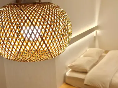 a large light fixture hanging over a bed at \u685c\u5357\u5927\u585a\u30cf\u30a6\u30b9 i in Tokyo