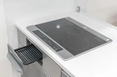 a stove top oven with a tablet on top of it at Downtown Mix in Tokyo