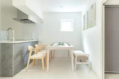 a kitchen with a white table and chairs at Downtown Mix in Tokyo