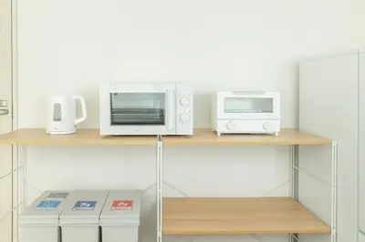 a microwave and a toaster oven on a shelf at Downtown Mix in Tokyo